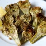 A plate of roasted baby artichokes with lemon.