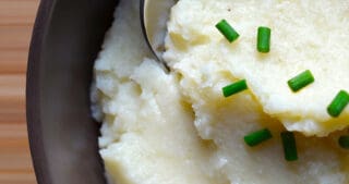 An overhead shot of a bowl filled with garlic caulflower mashed potatoes.