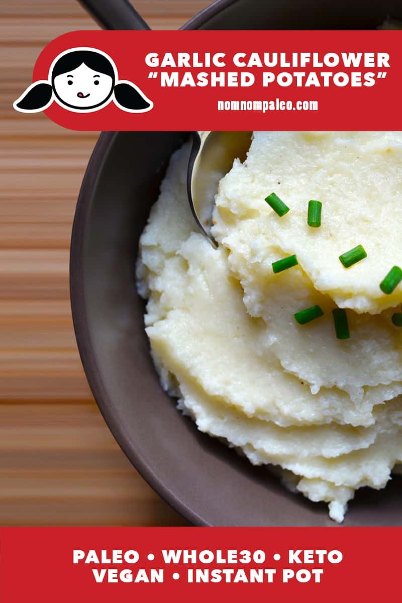 An overhead shot garlic cauliflower mashed potatoes in a brown bowl topped with chopped chives. There's a red banner that says its paleo, Whole30, keto, vegan, and Instant Pot.