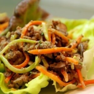 Paleo asian ground beef, mushroom, and broccoli slaw in lettuce cups.