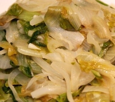 Paleo and Whole30 braised escarole with onions on a plate.