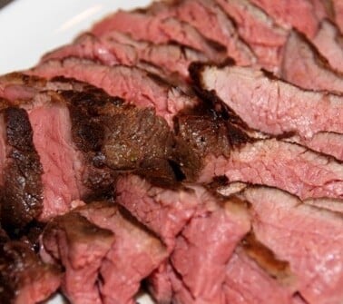 A plate of paleo and Whole30 sous vide grass fed tri-tip roast sliced up.