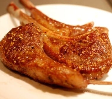 A plate of seared sous vide lamb chops.