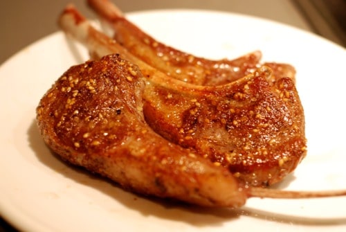 A plate of seared sous vide lamb chops.