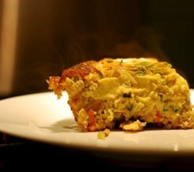 A slice of the paleo and whole30 curried ground pork and broccoli slaw frittata.