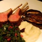 A plate of Whole30 roasted rack of lamb with a side of mashed cauliflower puree.