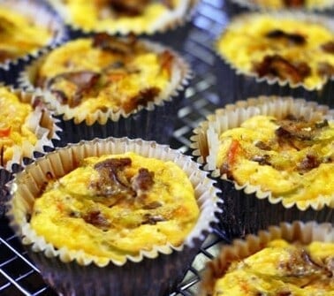 Curried beef, broccoli slaw, and mushroom frittata muffins sitting on a cooling rack.
