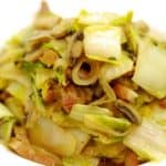 A bowl of the Whole30 and paleo recipe of stir fried napa cabbage with mushrooms and bacon.