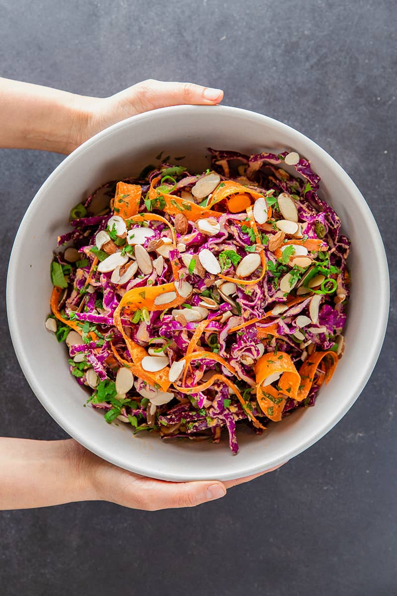 Overhead shot of Whole30 and paleo red cabbage slaw with tangy carrot and ginger dressing