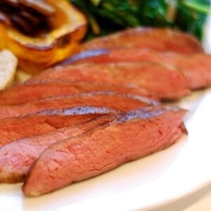 A plate of flank steak cooked sous vide cut up into thin strips.