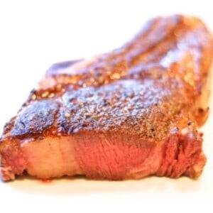 A sous vide grass fed rib steak or cowboy steak on a plate.