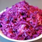 Braised red cabbage piled high on a white plate.