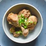 Bowl of lemongrass and coconut chicken drumsticks cooked in a slow cooker.