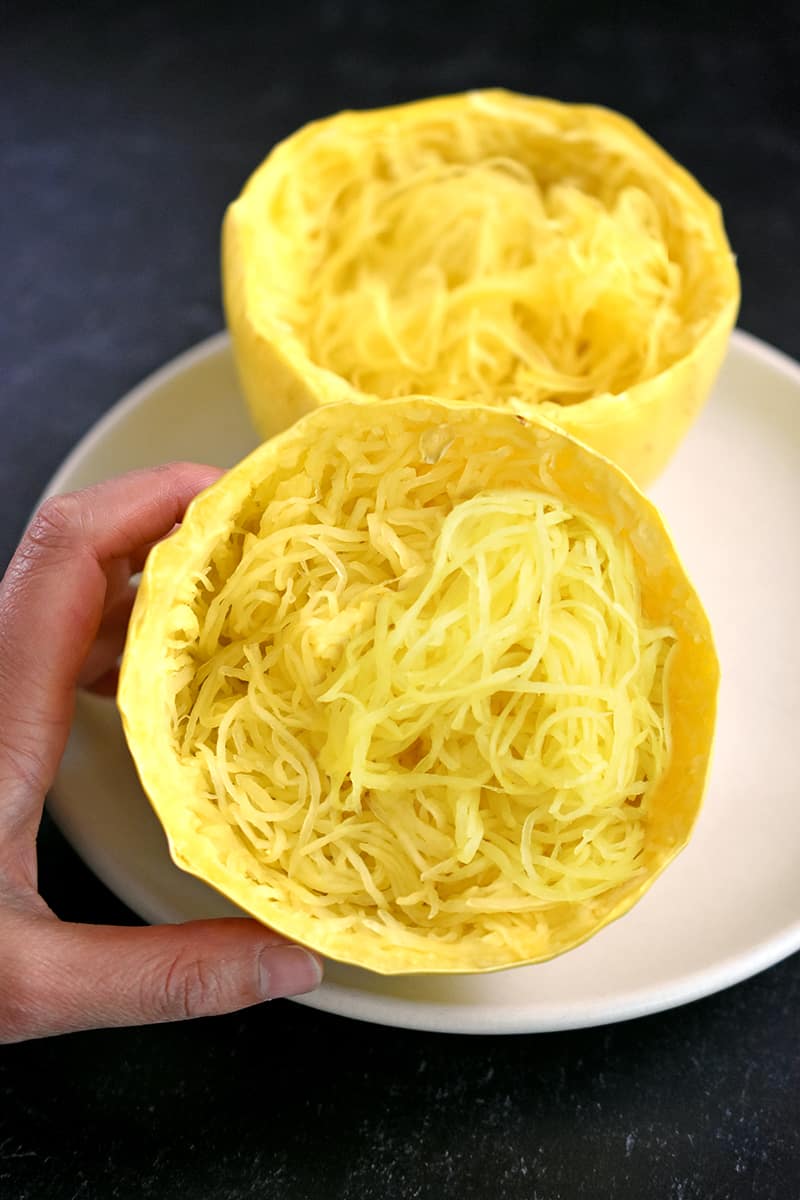 An overhead view of spaghetti squash cooked in the microwave and shredded with a fork.