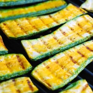 Zucchini grilling on a grill.