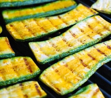 Zucchini grilling on a grill.