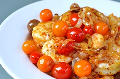 Sautéed Shrimp with Onions and Cherry Tomatoes on a plate.