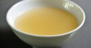 A bowl of Instant Pot Bone Broth in a white bowl