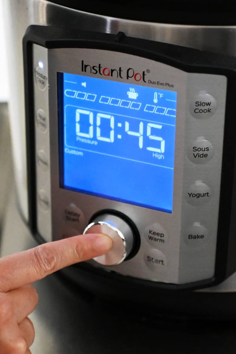 An Instant Pot display that shows it is programmed to cook for 45 minutes under high pressure.