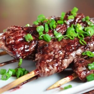A closeup of Whole30-friendly steak skewers with cherry barbecue sauce.