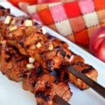 A closeup shot of Whole30-friendly Peachy Pork-A-Bobs, grilled pork skewers with a spicy peach barbecue sauce