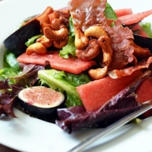 Plate of fig and watermelon salad with honey vanilla cashews