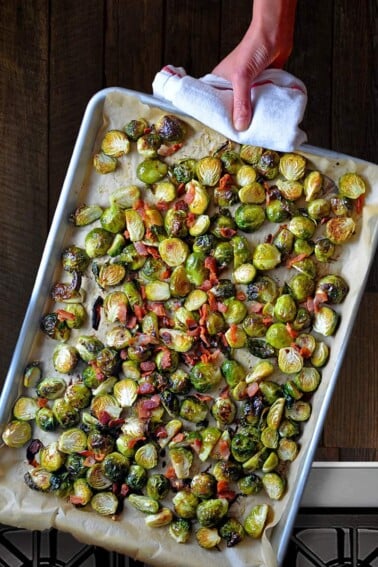 An overhead shot of a rimmed baking sheet filled with Roasted Brussels sprouts with Bacon.