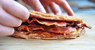 A side view of a Bacon Pancake Sandwich