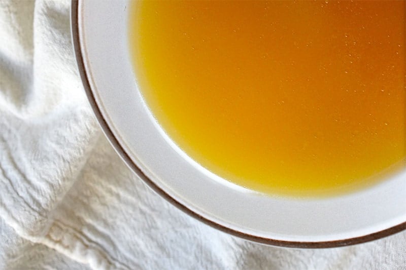 An overhead shot of a bowl of Quick Pressure Cooker Bone Broth 