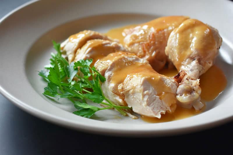 A side shot of a platter of Instant Pot Chicken and Gravy