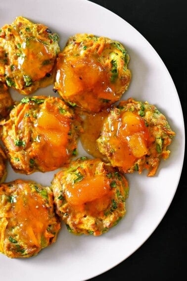 An overhead shot of Curry Turkey Bites topped with Apricot Ginger Sauce on a white plate.
