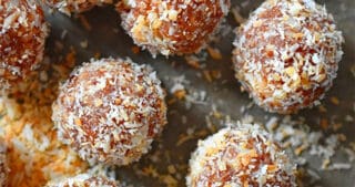An overhead shot of healthy, paleo, no-cook energy balls on a piece of parchment paper.
