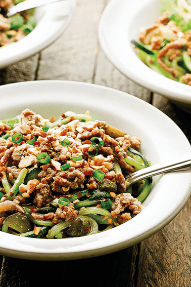 This fast Whole30-friendly Dan Dan Noodles uses zucchini noodles to make it paleo, cornichons for an acidic tang, and a separate chili oil for heat!
