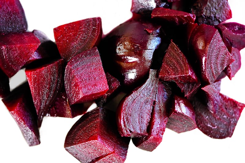 A pile of cooked, peeled, and chopped beets.