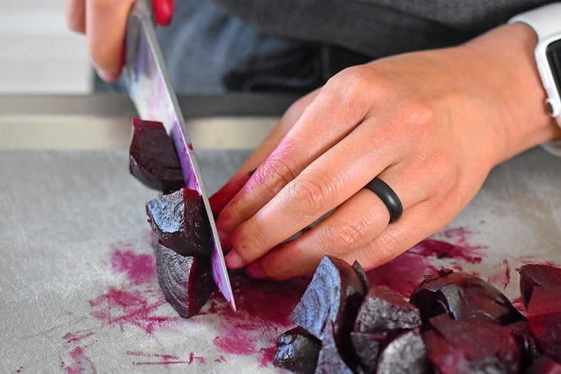 Someone cutting instant pot cooked beets.