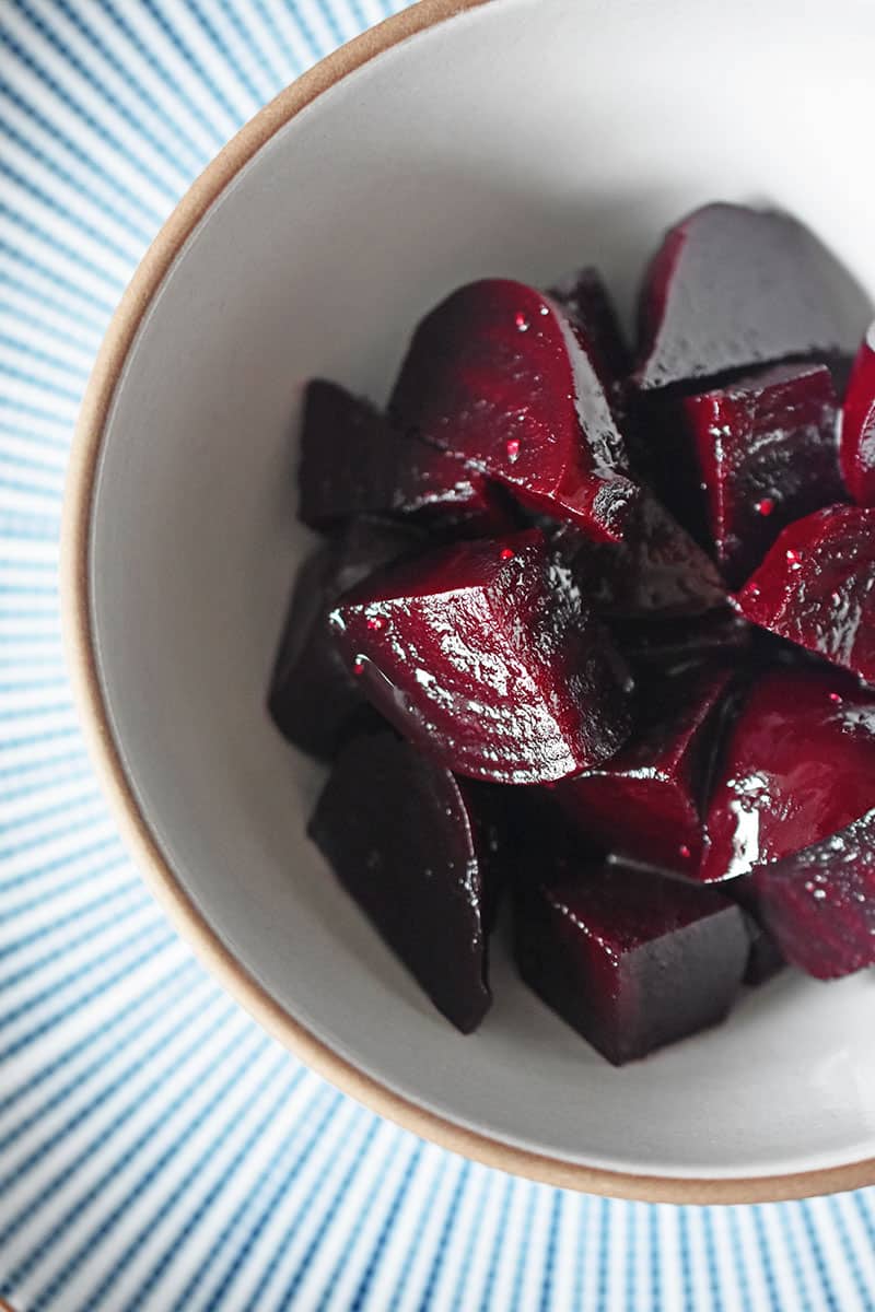 A bowl of quartered beets that were cooked in an Instant pot.