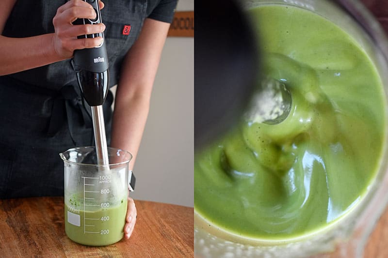 Someone mixing the ingredients for matcha coconut gummies with an immersion blender.