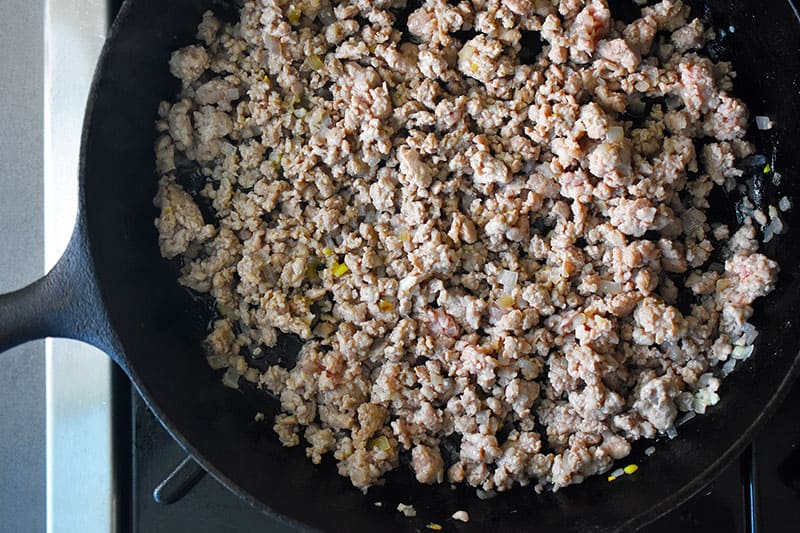 An overhead shot of the cooked ground pork in a skillet 