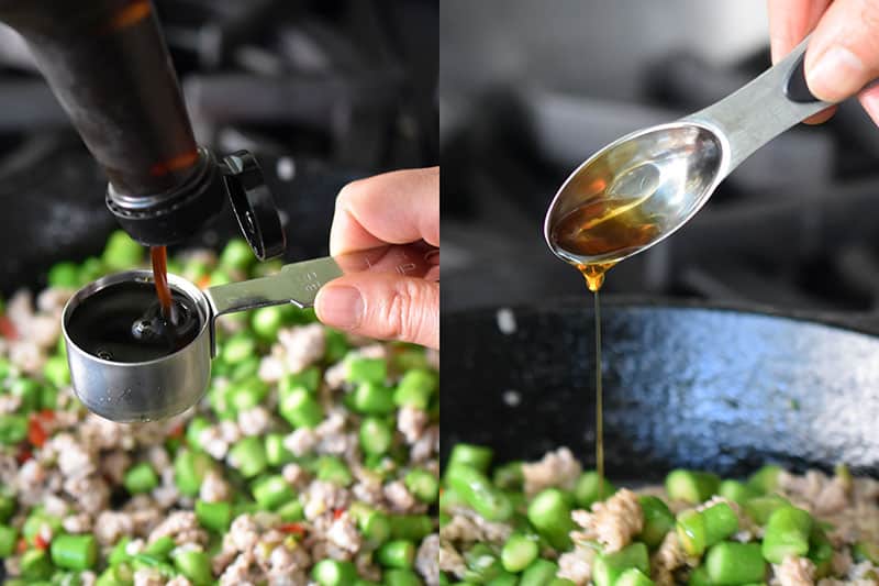 Pouring in the seasoning for Spicy Pork and Asparagus Stir-Fry 