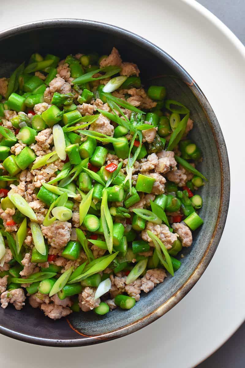 An overhead closeup shot of Spicy Pork and Asparagus Stir-Fry in a serving bowl, a Whole30 and keto weeknight dinner!