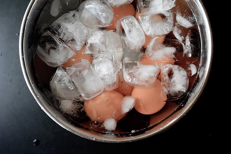 Hard cooked eggs chilling in an ice bath.