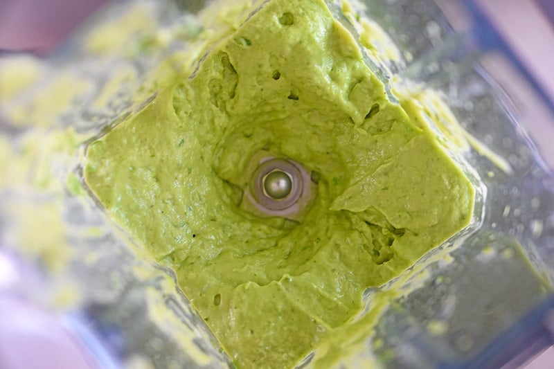 An overhead shot of creamy Avocado Crema in an open Vitamix blender.