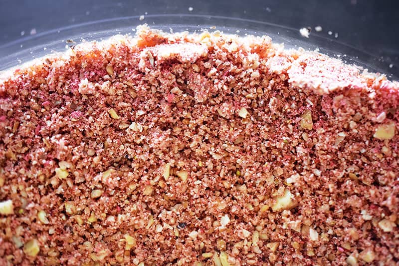 A closeup of the powdered fruit and chopped nuts used to make “PB&J” Energy Balls.