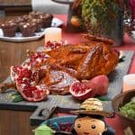 A shot of a Paleo Thanksgiving table with a spatchcock turkey and all the side dishes.