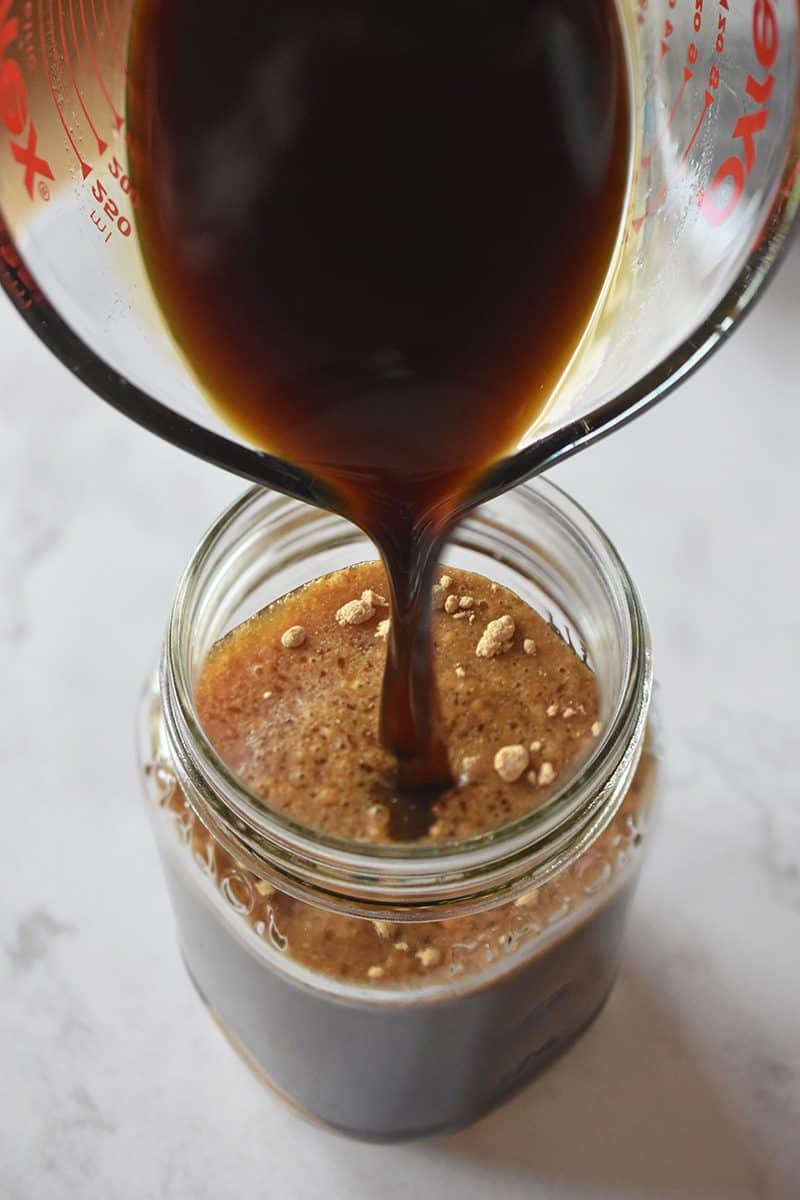 Pouring the ingredients of All-Purpose Stir-Fry Sauce into a mason jar