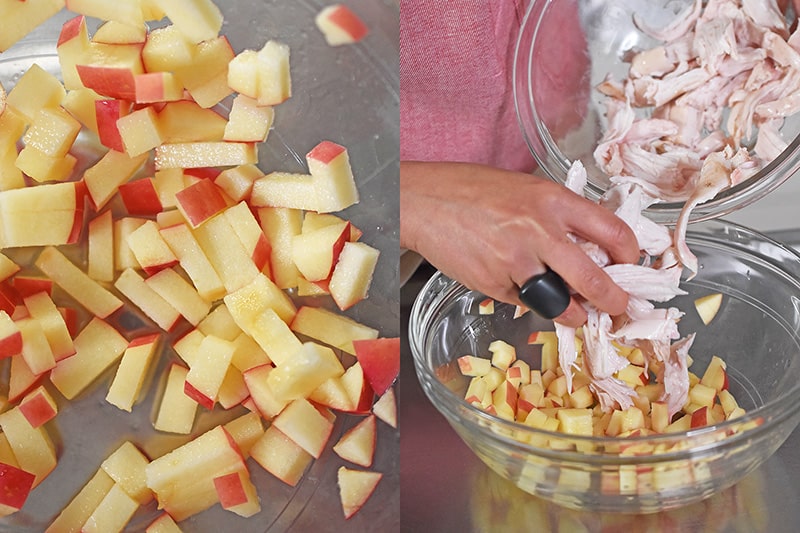 Someone adding cooked shredded chicken into a bowl with diced apples.