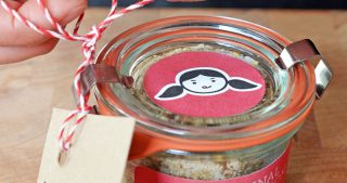 A jar of Magic Mushroom Powder with a tag that says Happy Holidays