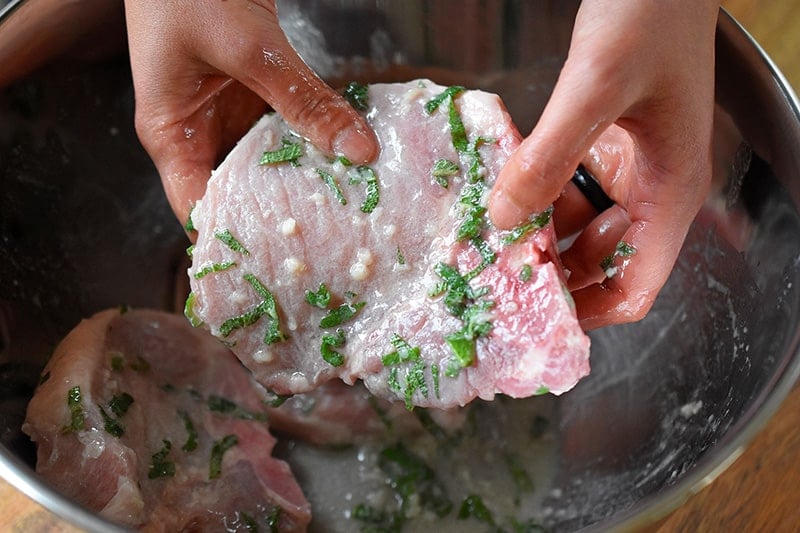 A pork chop covered in marinade