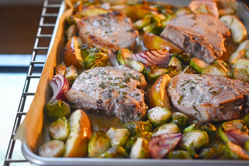 A shot of Sheet Pan Pork Chop Supper baking in the oven.