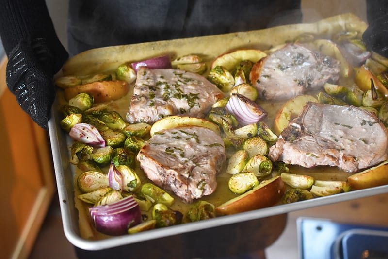 Removing Sheet Pan Pork Chop Supper from the oven.